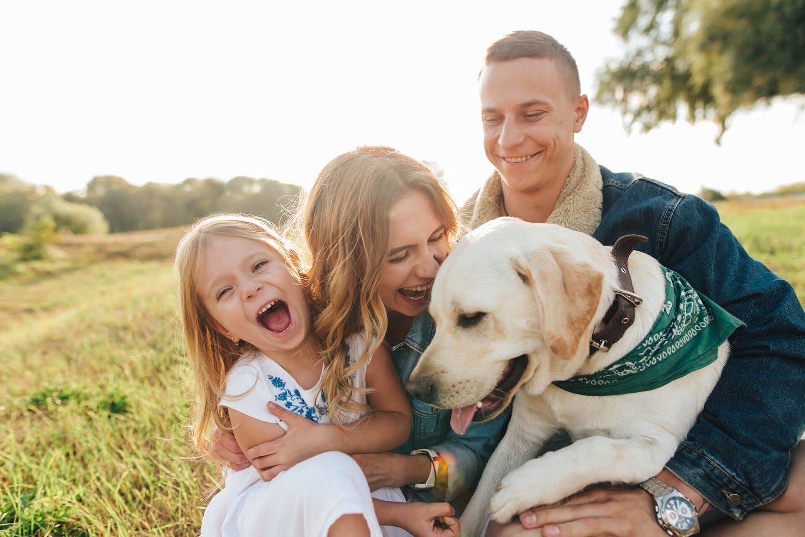 Family and dog outside getting cuddles