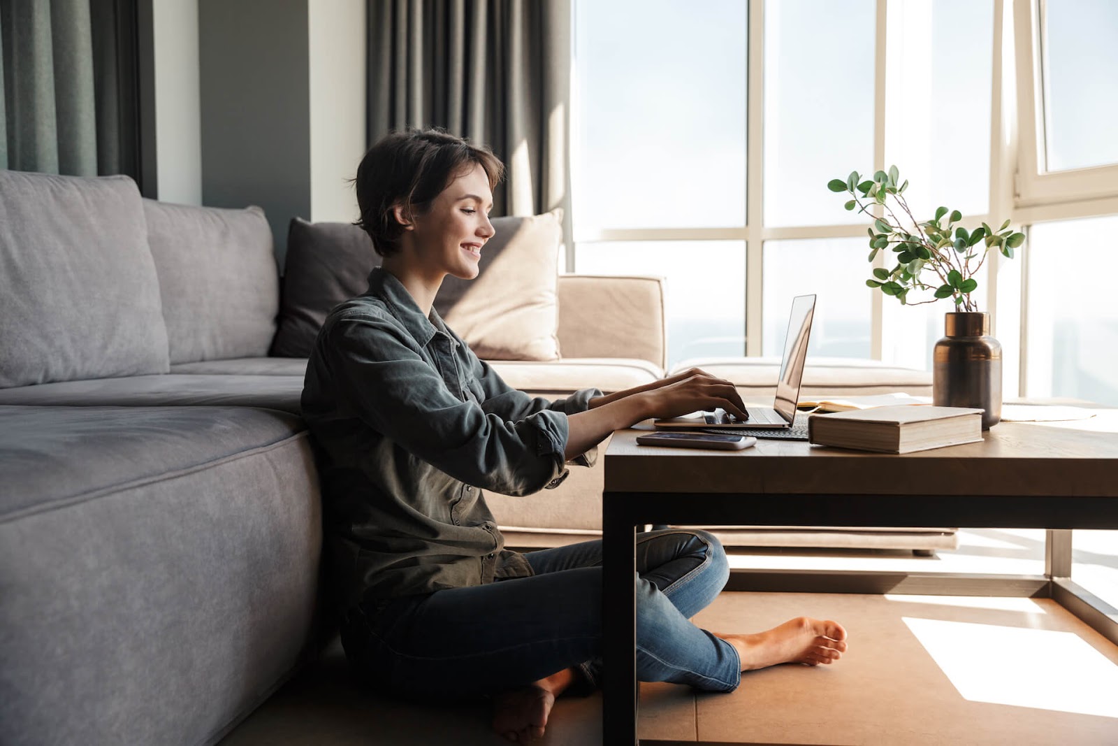 Woman working on her laptop on the floor