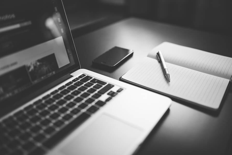 Cheap laptop for college student with notebooko and pen nearby
