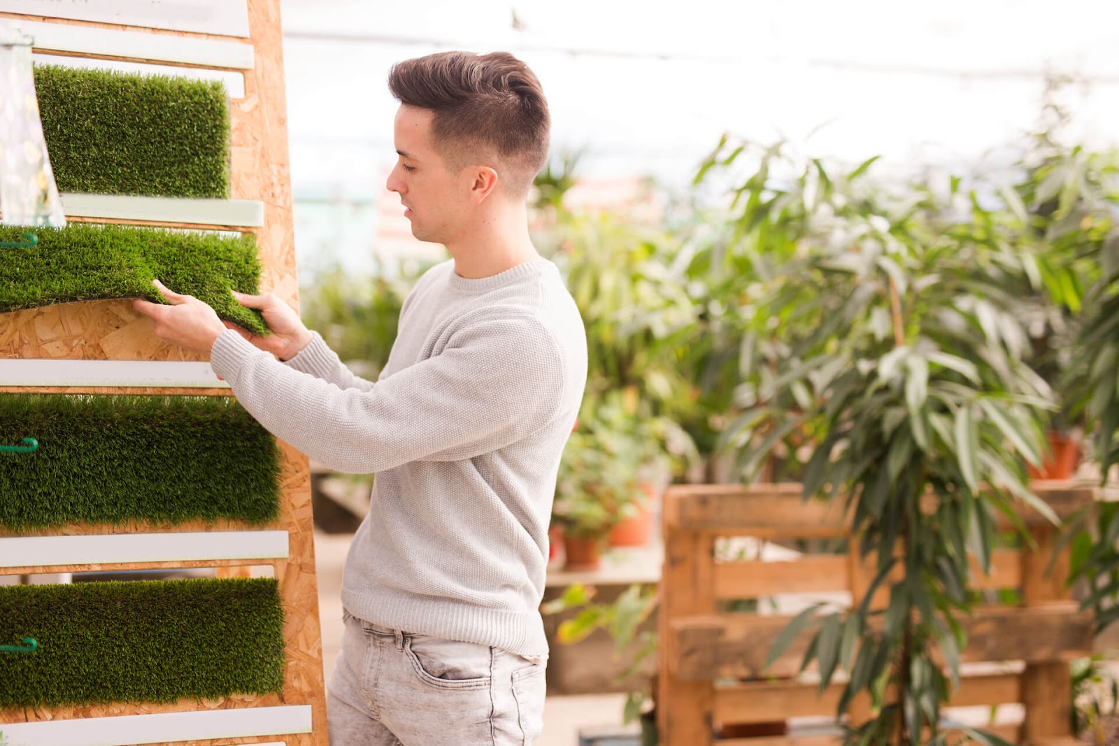 Man looking at artificial grass options