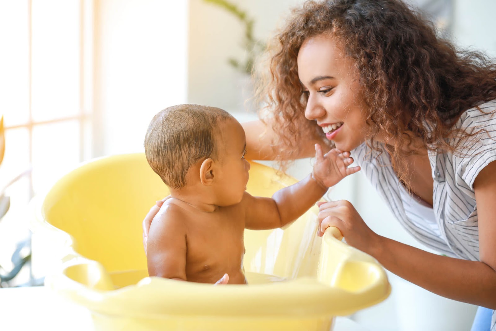 Mom and toddler playing during bathtime