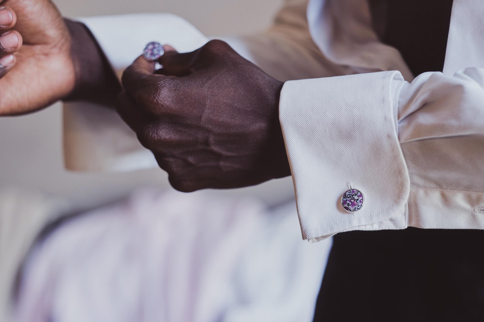 Man Putting on cufflinks