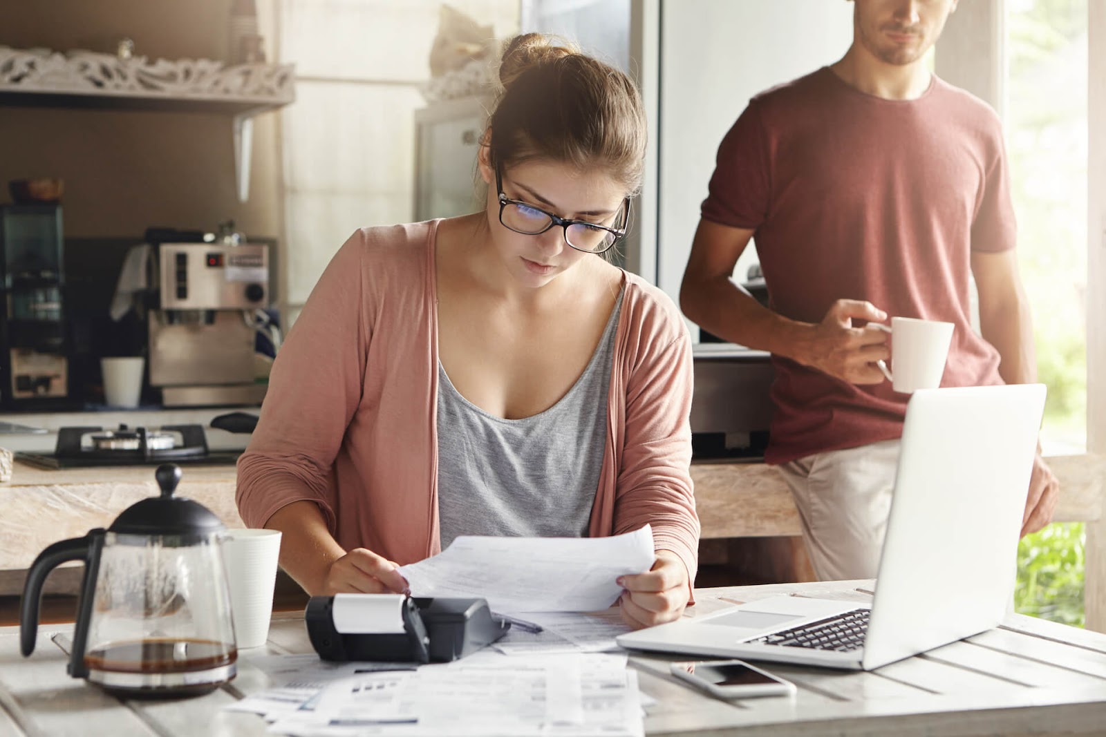Woman looking over their budget to see if she can afford to be a stay at home mom