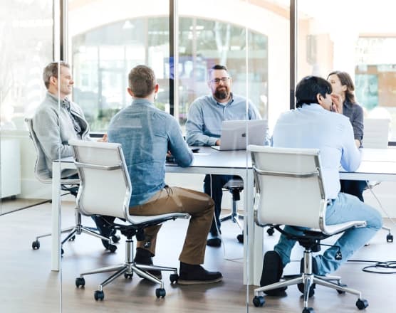 People having a meeting on a glass room.