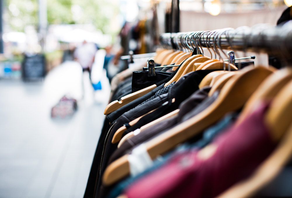 Rack of clothing on hangers outside of a store