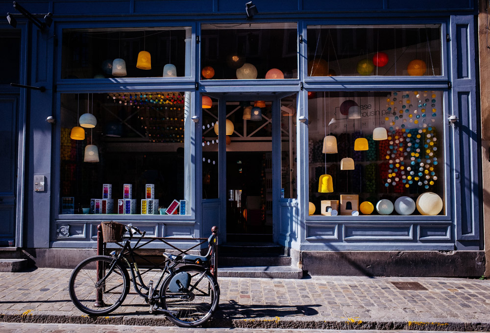 blue storefront with bike parked in front