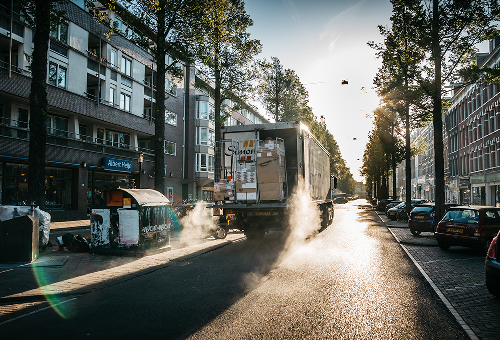 Delivery truck on city street at sunrise