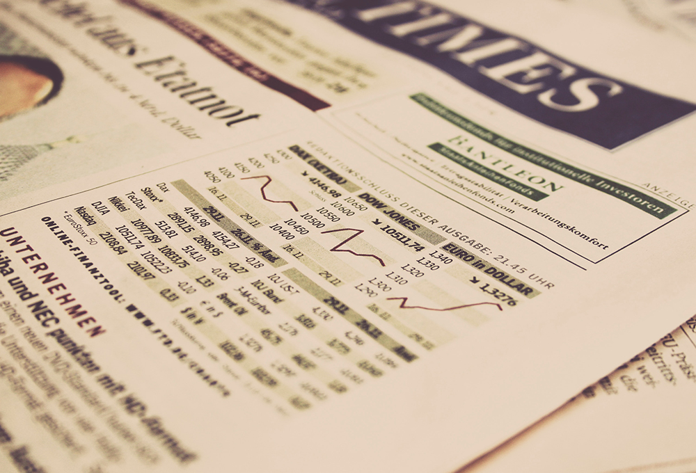 Close up of newspaper page with stock market graph