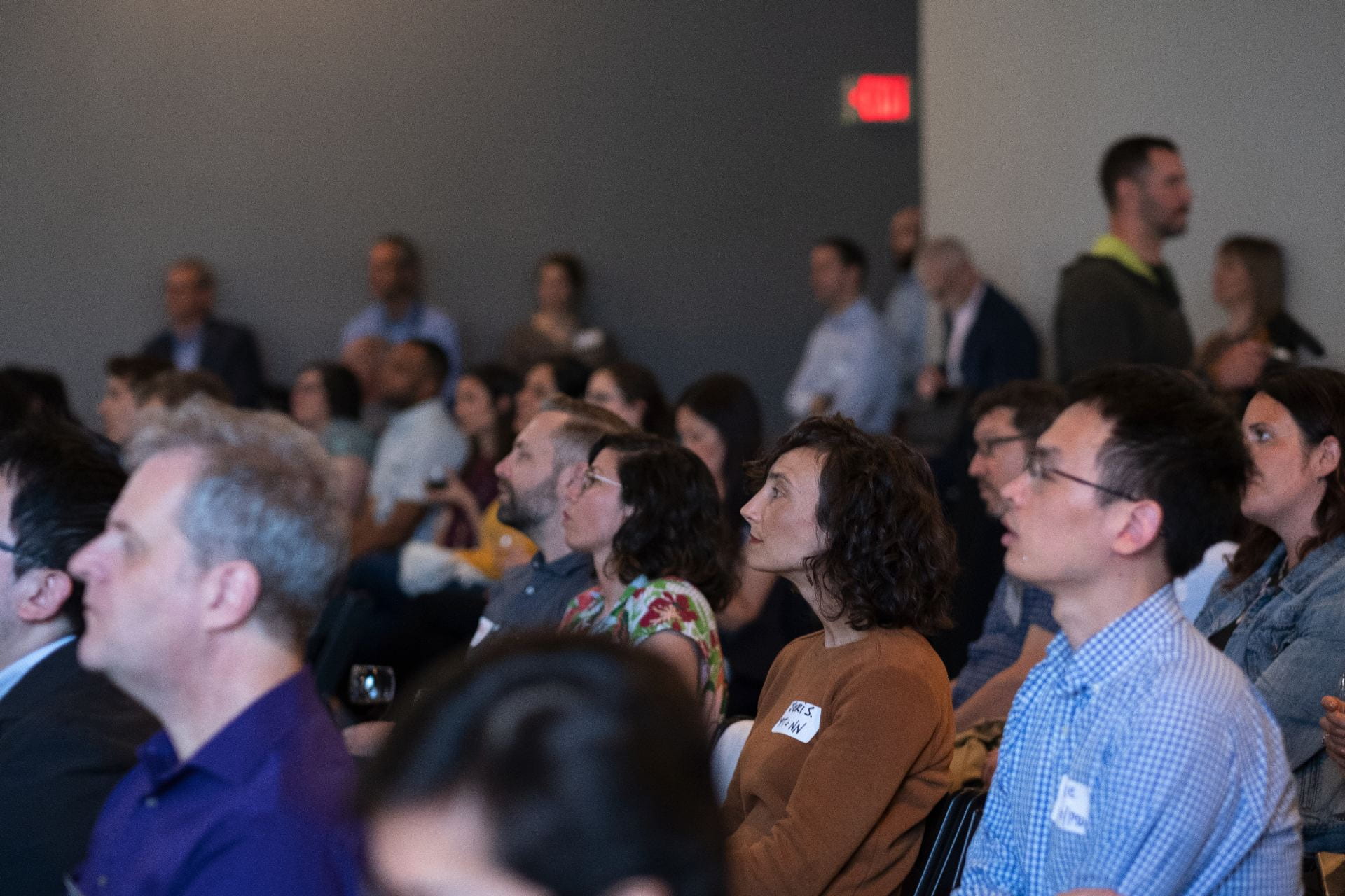 A group of people sitting and watching an event