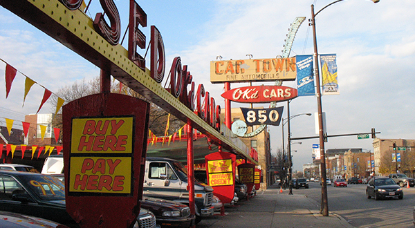 Used car dealership next to a town street