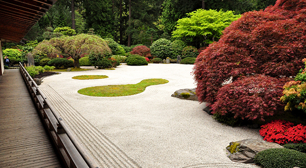 Wooden walkway next to Japanese stone garden