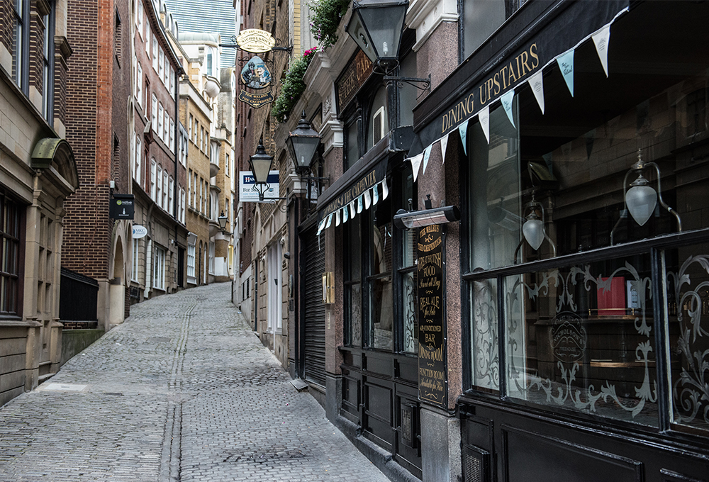 Narrow winding street in front of restaurant in London