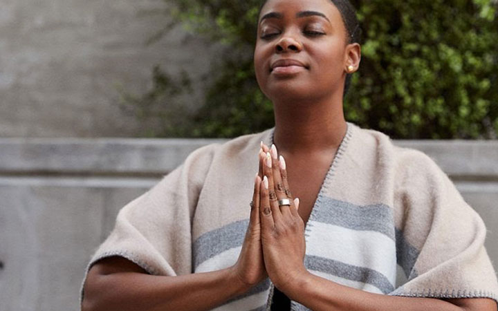 user meditates with oura ring