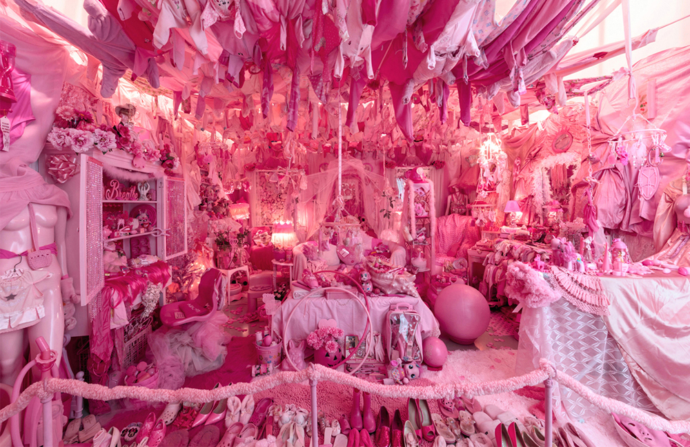 room full of pink objects and all the furniture is covered in pink fabric with pink hanging from the ceiling