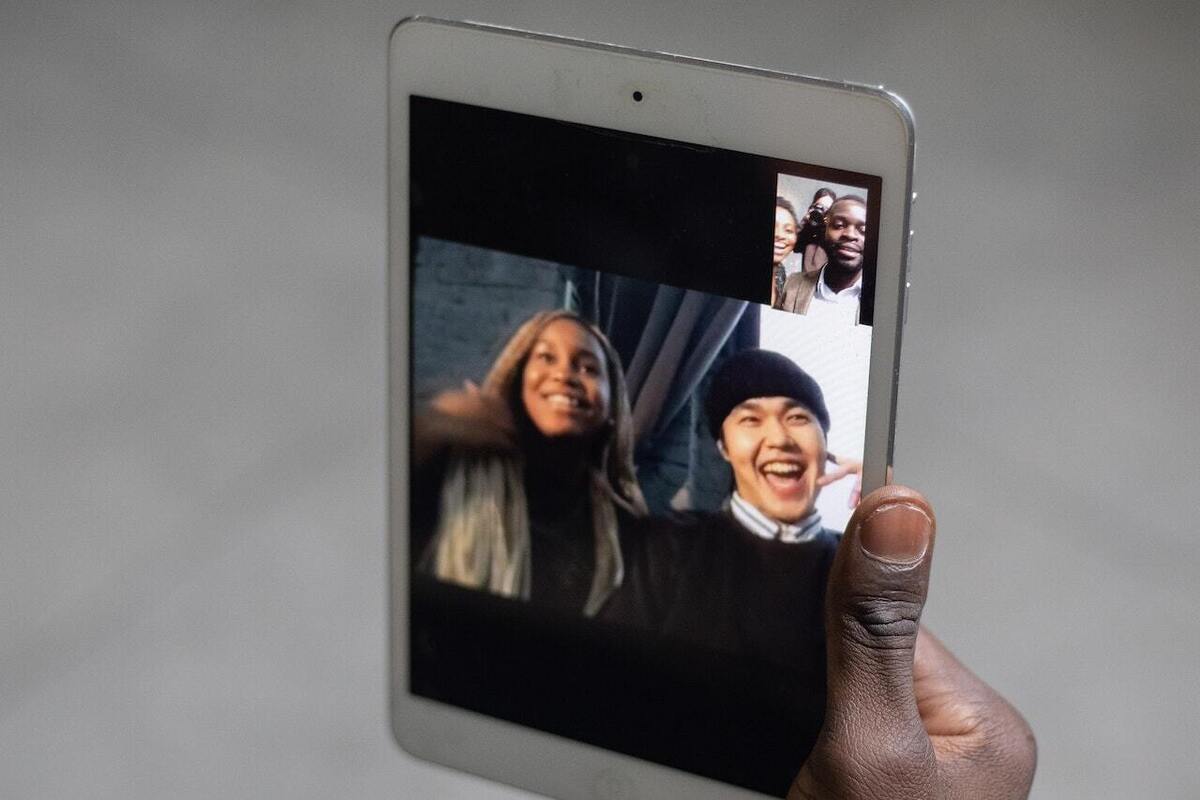 A group of friends on a video call on a tablet