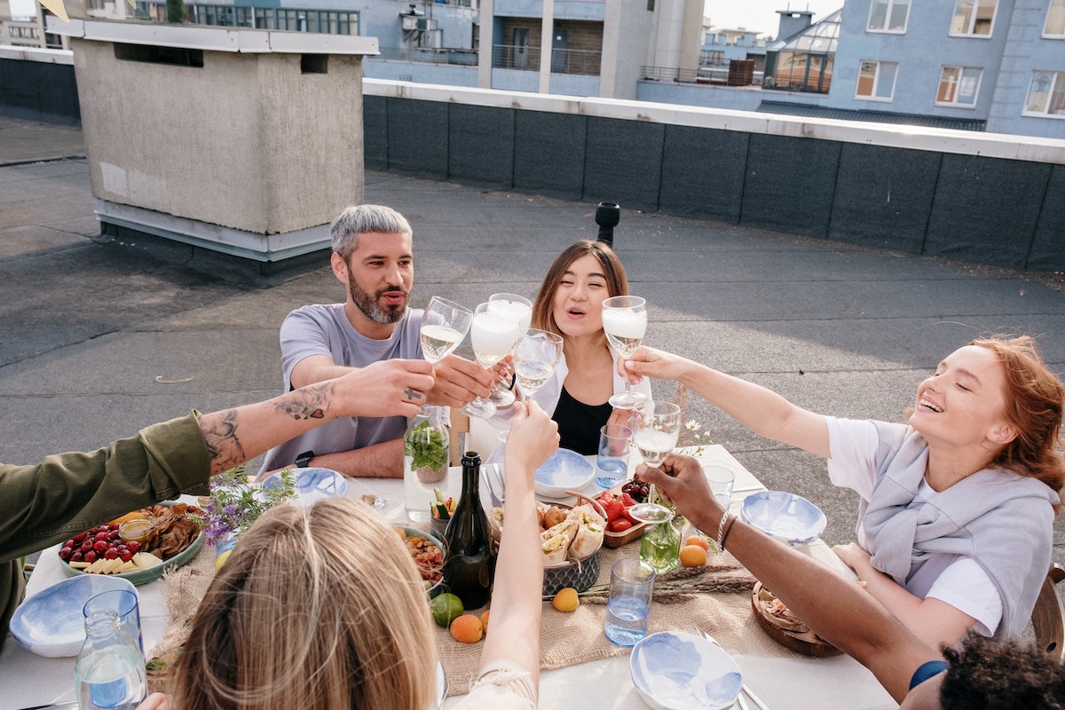 A group of friends having dinner party outside