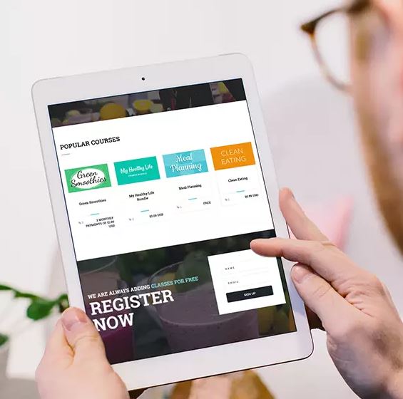 Man holding iPad featuring online course storefront