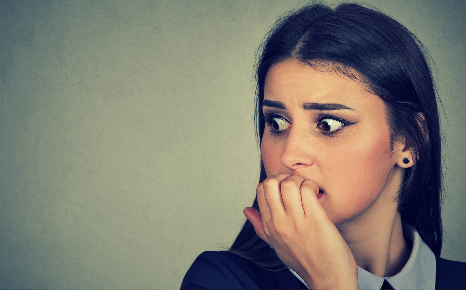 anxious woman biting her nails