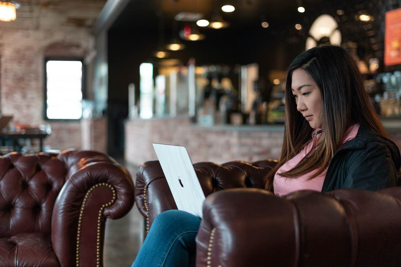 Woman on a laptop excited to sell her online course