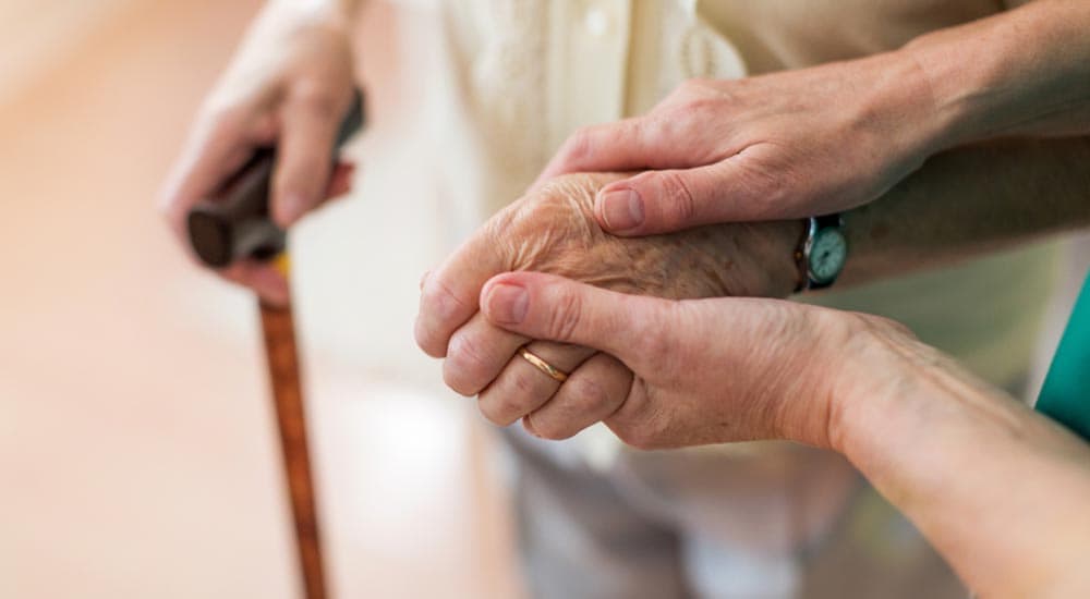 nurse helping elderly woman