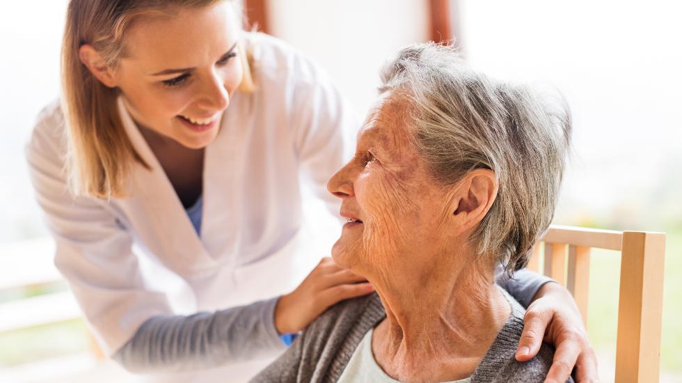 carer smiling at elderly patient