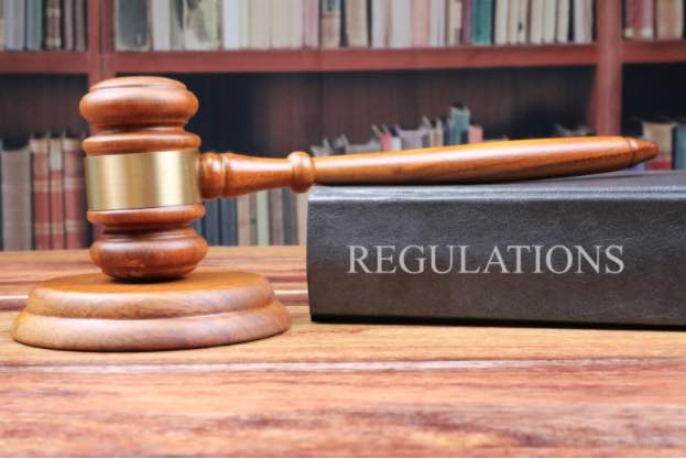 A mallet and a book of regulations