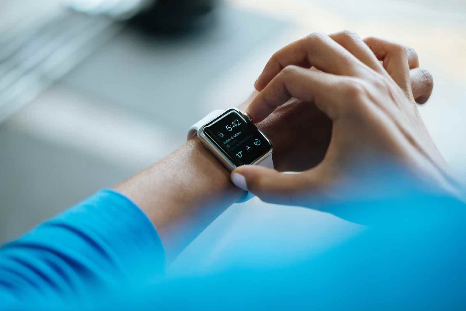 An employee checking the time on her watch
