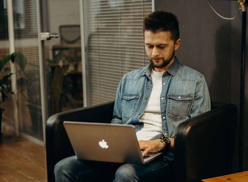 Man working on Apple laptop