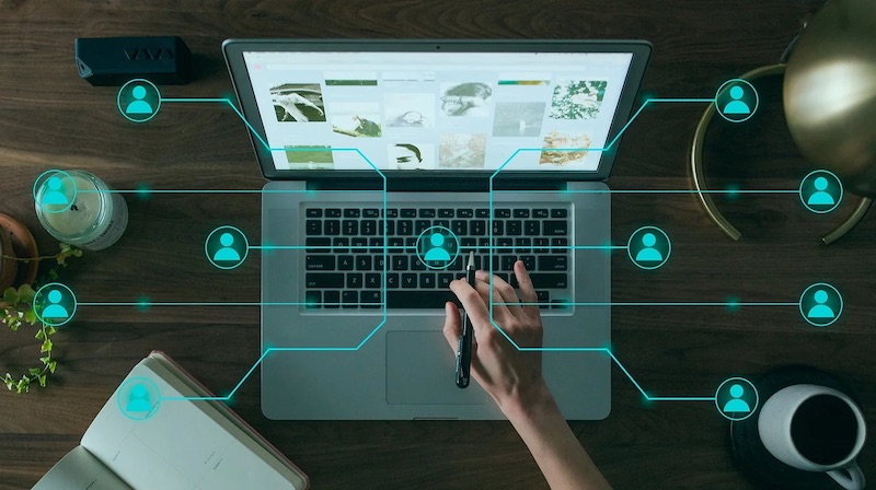 Referral network web hovering over laptop used by woman