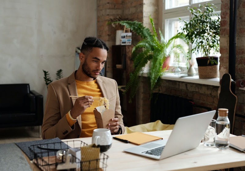 A male recruiter looking at a desktop computer