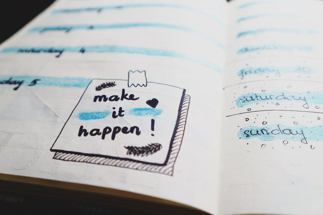 "make it happen" written in a planner