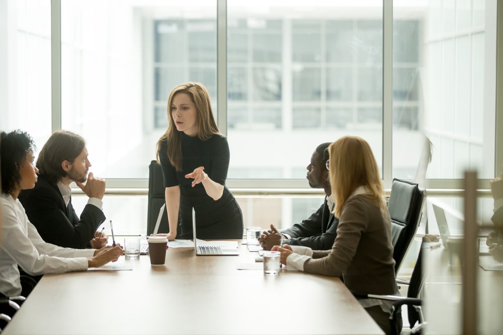 Businesswoman Delegating Work to Team