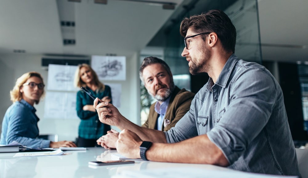 Businessman at Work in Meeting with Colleagues