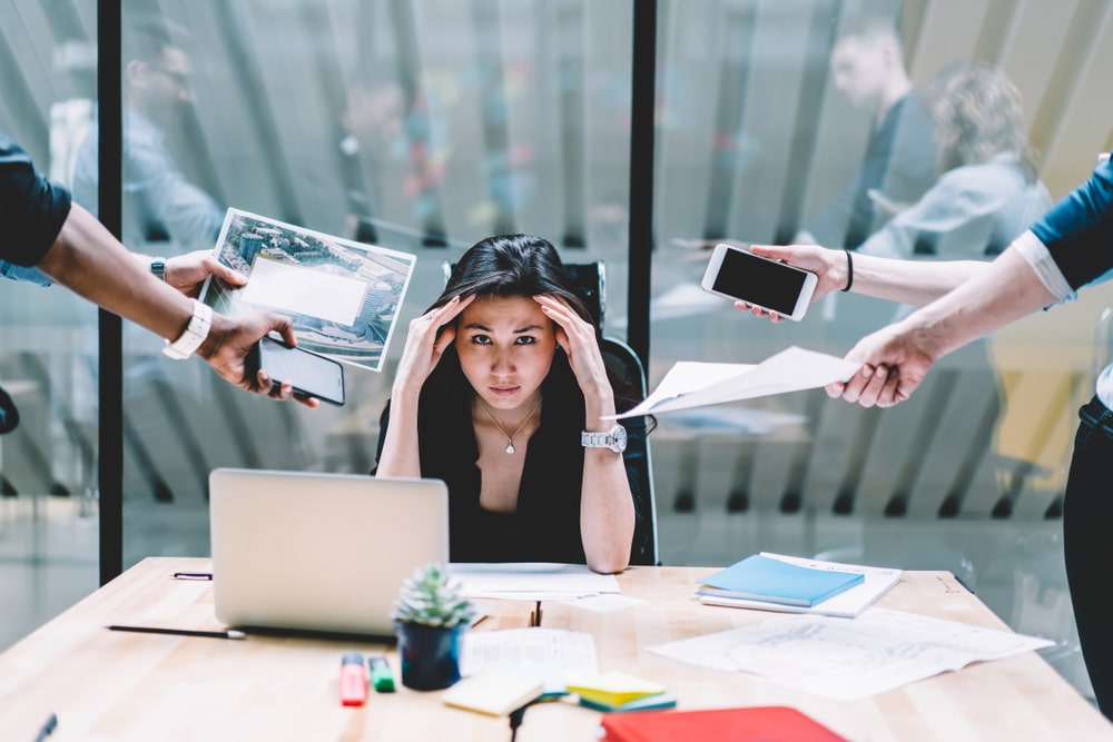 Stressed Female Employee With Too Many Requests