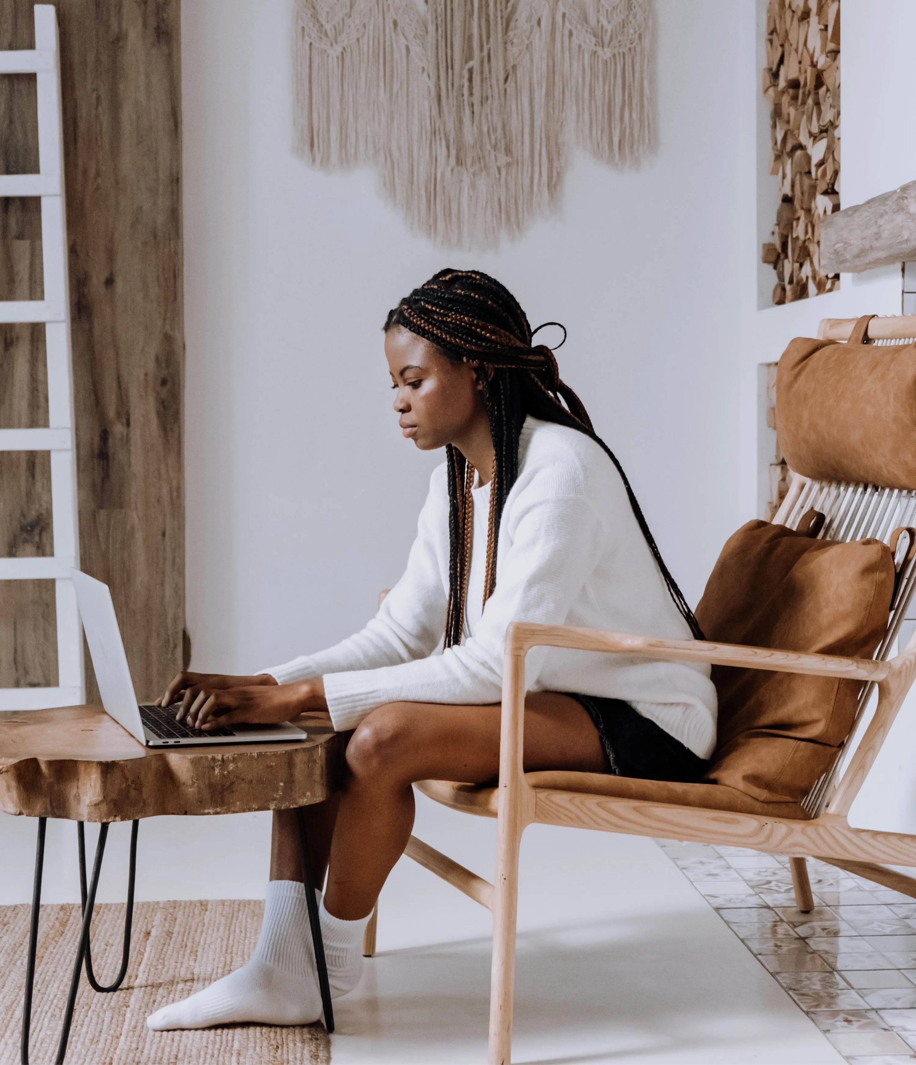 A woman working on a laptop on a couch