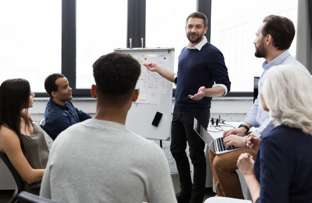 Business team discussing their ideas while working in office Free Photo