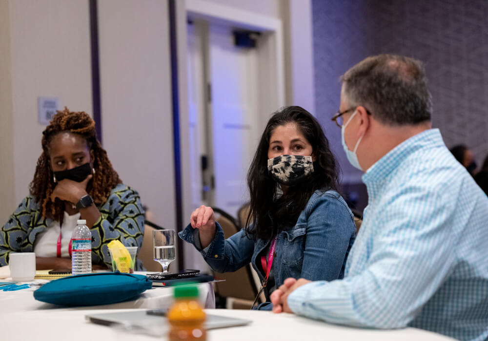 ADI attendees in a small-group discussion.