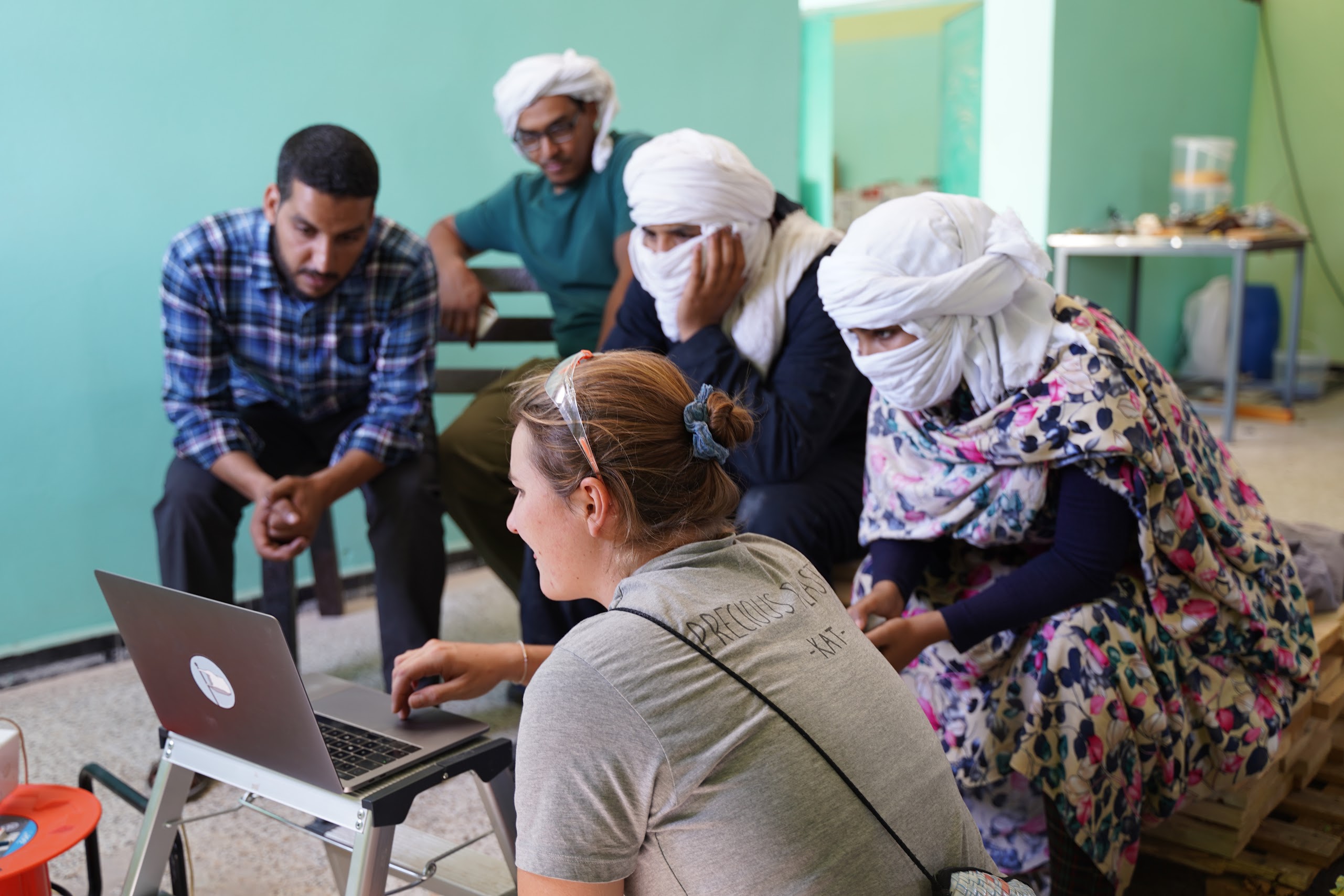Woman giving a recycling workshop to refugees
