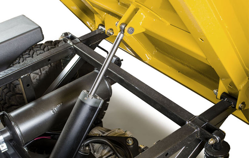 Image of the underside of a utility vehicle bed tipped up to show the dump mechanism.