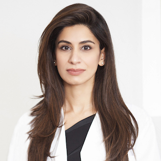 Dr. Asima Ahmad in a white coat