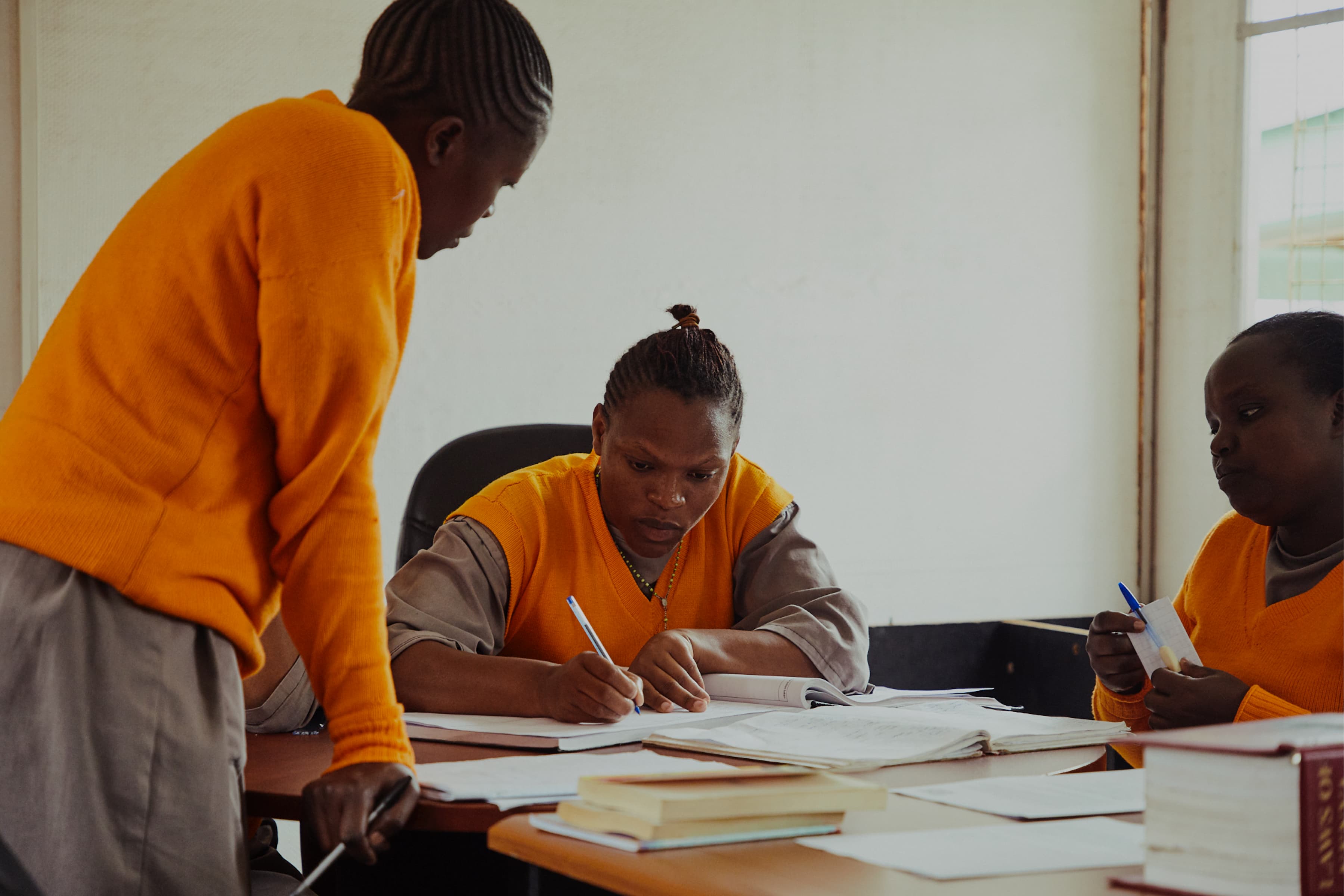 Two Justice Defenders female prisoners study togehther 