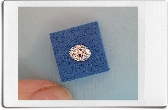 Oval shaped diamond on blue foam square