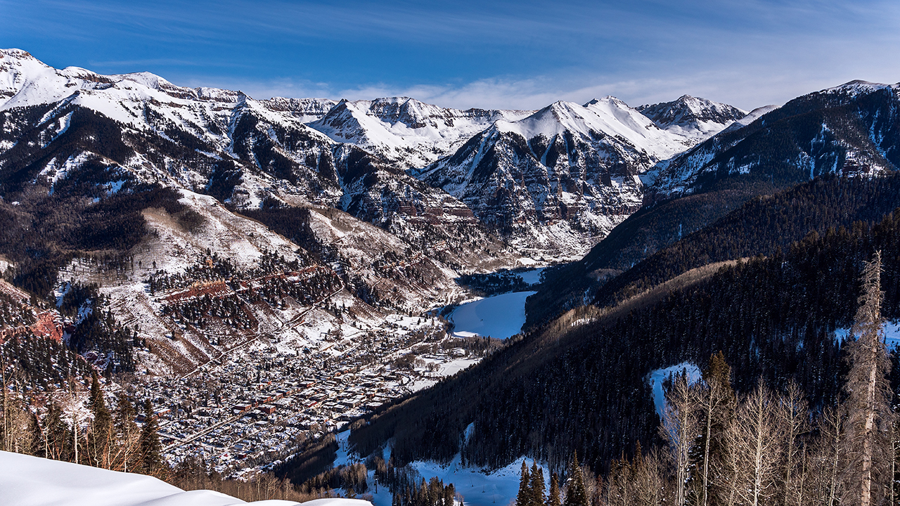 scenic view of the town of Telluride from the mountains with snow