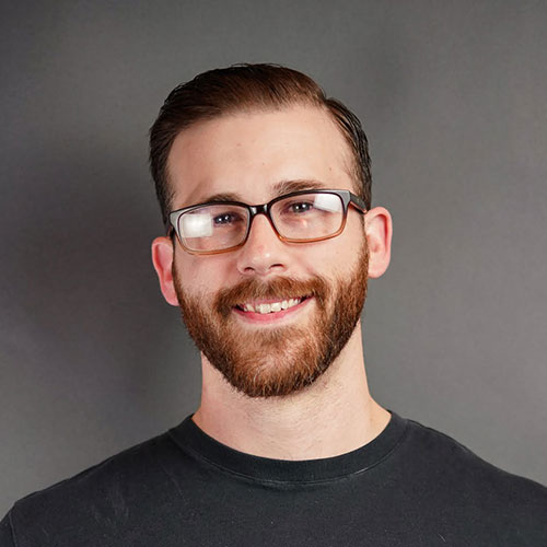young man with brown hair and glasses