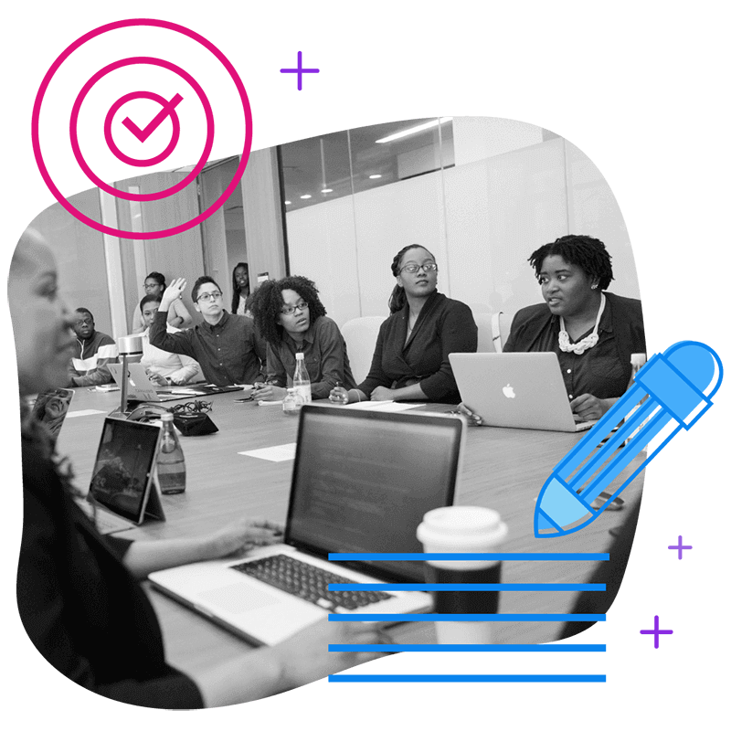 diverse group of people in a meeting with laptops and tablets discussing and goal setting