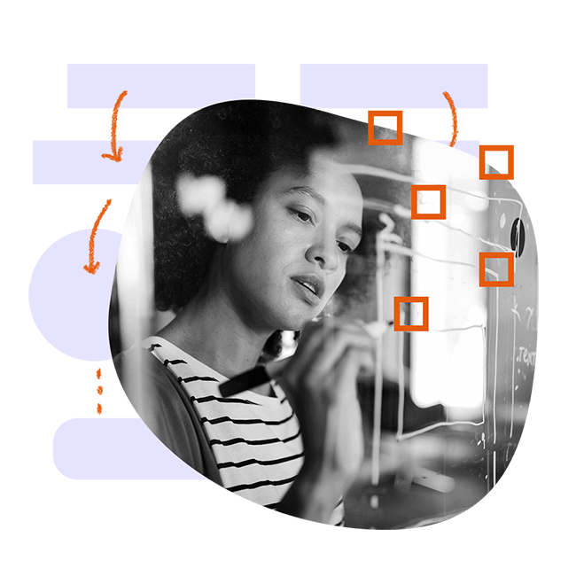 woman writing on a whiteboard with process graphics