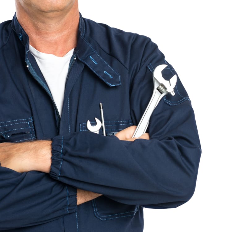 a maintenance man standing holding a wrench