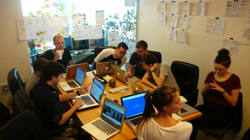 The team in a conference room with laptops