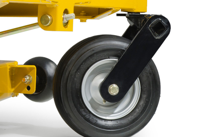 Image of a black front fork with the front tire mounted on a yellow mower