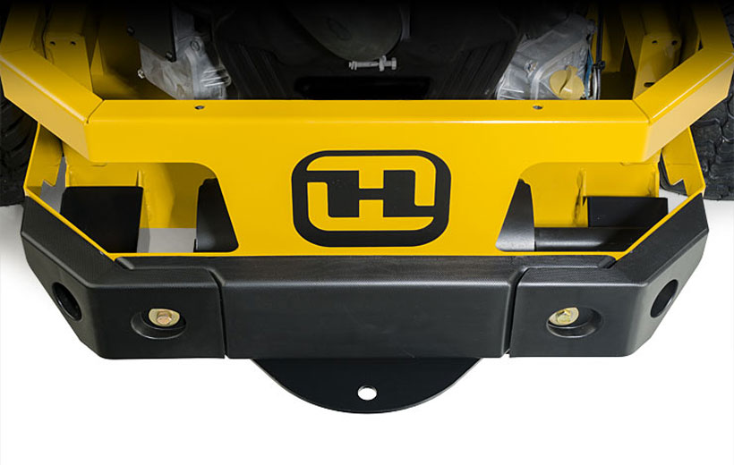 Image of the rear engine guard of a mower wrapped with a black thick plastic guard.